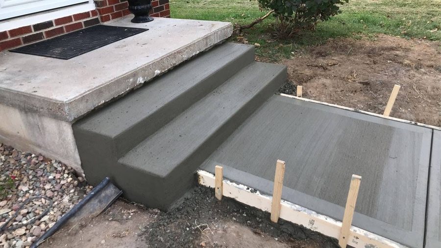 Freshly poured concrete steps and landing with the adjoining walk still in forms